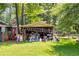 View of a messy outdoor storage shed overflowing with equipment surrounded by lush greenery at 4544 Ridgeview Dr, Powder Springs, GA 30127