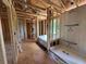 Unfinished bathroom showcasing the stud framing for a walk-in shower and a built-in tub at 5371 Heron Bay Blvd, Locust Grove, GA 30248