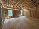 Unfinished bedroom with natural light showcasing the stud framing and planned layout at 5371 Heron Bay Blvd, Locust Grove, GA 30248