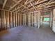 Unfinished living room showcasing the stud framing and the planned spacious layout of the home at 5371 Heron Bay Blvd, Locust Grove, GA 30248
