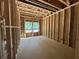 Unfinished living room with natural light showcasing the stud framing and planned spacious layout at 5371 Heron Bay Blvd, Locust Grove, GA 30248