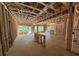 Unfinished living room with natural light showcasing the stud framing and planned spacious layout of the home at 5371 Heron Bay Blvd, Locust Grove, GA 30248