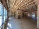 Unfinished living room with natural light showcasing the stud framing, fireplace, and staircase at 5371 Heron Bay Blvd, Locust Grove, GA 30248