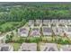 Aerial view of a quiet neighborhood featuring manicured lawns, mature trees, and a peaceful pond at 11375 Crestview Ter, Johns Creek, GA 30024