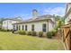 Well-maintained backyard with green grass, trimmed hedges, and a view of the home's exterior at 11375 Crestview Ter, Johns Creek, GA 30024
