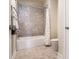 Bathroom with tiled tub and shower combination at 11375 Crestview Ter, Johns Creek, GA 30024