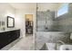 Modern bathroom with a glass-enclosed shower, dual vanity, and walk-in closet access at 11375 Crestview Ter, Johns Creek, GA 30024