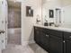 Bathroom with shower and dark wooden cabinets at 11375 Crestview Ter, Johns Creek, GA 30024