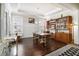 Dining room with tray ceilings, natural light, and dark wood floors are perfect for entertaining at 11375 Crestview Ter, Johns Creek, GA 30024