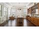 Dining room with tray ceilings, natural light, and dark wood floors are perfect for entertaining at 11375 Crestview Ter, Johns Creek, GA 30024