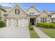 Charming brick home with a two-car garage, complemented by manicured landscaping at 11375 Crestview Ter, Johns Creek, GA 30024