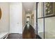 Hallway with dark wood floors leads to the rest of the house with white trim and light colored walls at 11375 Crestview Ter, Johns Creek, GA 30024