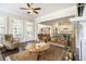 Cozy living room with natural light, dark wood floors, fireplace and access to other living spaces at 11375 Crestview Ter, Johns Creek, GA 30024