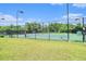 Well-maintained community tennis court surrounded by fencing and lush greenery at 11375 Crestview Ter, Johns Creek, GA 30024