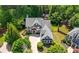 Aerial view of a beautiful home surrounded by mature trees and lush landscaping at 2301 Kirk Farm Nw Pl, Kennesaw, GA 30152
