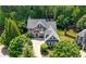 Aerial view of a beautiful home surrounded by mature trees and lush landscaping at 2301 Kirk Farm Nw Pl, Kennesaw, GA 30152