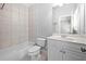 Bright bathroom features a tub, tile surround, vanity with storage, and neutral colors at 2301 Kirk Farm Nw Pl, Kennesaw, GA 30152