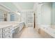 Elegant bathroom with dual vanities, soaking tub, and marble accents at 2301 Kirk Farm Nw Pl, Kennesaw, GA 30152