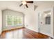 Bedroom featuring a ceiling fan, hardwood floors, and a window with wooded backyard views at 2301 Kirk Farm Nw Pl, Kennesaw, GA 30152