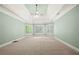 Large bedroom with tray ceiling, fan, and windows with views to the outside at 2301 Kirk Farm Nw Pl, Kennesaw, GA 30152