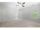 Neutral bedroom featuring a ceiling fan, closet, large window with blinds, and neutral colored carpet at 2301 Kirk Farm Nw Pl, Kennesaw, GA 30152