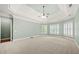 Bright bedroom with tray ceiling, carpet, and view from windows at 2301 Kirk Farm Nw Pl, Kennesaw, GA 30152