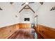 Bonus room featuring hardwood floors, wood paneling, exposed wood beams, a bar and a television at 2301 Kirk Farm Nw Pl, Kennesaw, GA 30152