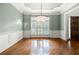 Elegant dining room with hardwood floors, chandelier, and detailed trim work at 2301 Kirk Farm Nw Pl, Kennesaw, GA 30152