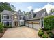 Beautiful two-story home with stone accents, three-car garage, and well-manicured landscaping at 2301 Kirk Farm Nw Pl, Kennesaw, GA 30152