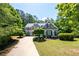 Charming two-story home featuring lush landscaping and a curved driveway at 2301 Kirk Farm Nw Pl, Kennesaw, GA 30152