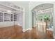Elegant interior showcasing hardwood floors, archways, and custom built-in shelving at 2301 Kirk Farm Nw Pl, Kennesaw, GA 30152