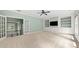 Living room featuring built-in shelving, a ceiling fan, large windows, and a french door entryway at 2301 Kirk Farm Nw Pl, Kennesaw, GA 30152