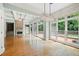 Bright living room featuring a stone fireplace, hardwood floors, and large windows overlooking the backyard at 2301 Kirk Farm Nw Pl, Kennesaw, GA 30152