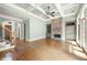 Large living room featuring a stone fireplace, coffered ceilings, and hardwood floors at 2301 Kirk Farm Nw Pl, Kennesaw, GA 30152