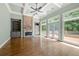 Spacious living room featuring a stone fireplace, hardwood floors, and coffered ceilings at 2301 Kirk Farm Nw Pl, Kennesaw, GA 30152