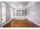 Bright office space with large windows, hardwood floors, and custom built-in bookshelves at 2301 Kirk Farm Nw Pl, Kennesaw, GA 30152
