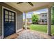 Inviting covered patio with stone flooring, offering a serene view of the expansive backyard and deck at 2301 Kirk Farm Nw Pl, Kennesaw, GA 30152