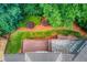 Aerial view of roof, back decks, lush backyard, and perimeter landscaping at 255 Beech Tree Holw, Sugar Hill, GA 30518