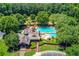 Aerial view of pool and recreation area surrounded by mature trees at 255 Beech Tree Holw, Sugar Hill, GA 30518
