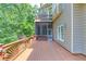 Lovely back deck with access to screened in porch, decorative railings, and shaded surroundings at 255 Beech Tree Holw, Sugar Hill, GA 30518