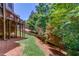 Grassy backyard with a mulch path, surrounded by trees at 255 Beech Tree Holw, Sugar Hill, GA 30518