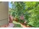 Multi-level back yard has deck access, a few trees, and a lush lawn at 255 Beech Tree Holw, Sugar Hill, GA 30518