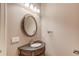 Bathroom features a decorative mirror and sink with ornate fixtures and lighting at 255 Beech Tree Holw, Sugar Hill, GA 30518