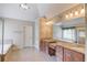 Spa-like bathroom boasts a double vanity and a soaking tub under a decorative window at 255 Beech Tree Holw, Sugar Hill, GA 30518