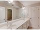 Bathroom featuring double sinks, a large mirror, white cabinets, and a tub-shower combo at 255 Beech Tree Holw, Sugar Hill, GA 30518