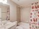 Bright bathroom featuring a vanity, toilet, and a tub-shower combo with decorative Coca-Cola-themed curtains at 255 Beech Tree Holw, Sugar Hill, GA 30518