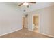 Bedroom with carpet, neutral paint, a fan, and doorways to the bathroom and hallway at 255 Beech Tree Holw, Sugar Hill, GA 30518