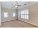 Spacious bedroom featuring neutral walls, carpet, a ceiling fan, and white trim and plantation shutters at 255 Beech Tree Holw, Sugar Hill, GA 30518