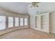 Large bedroom featuring carpeting, white shelving, crown molding, and natural light from several windows at 255 Beech Tree Holw, Sugar Hill, GA 30518
