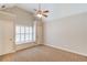 Bright bedroom with neutral walls, carpet, a ceiling fan, and a window with white shutters at 255 Beech Tree Holw, Sugar Hill, GA 30518